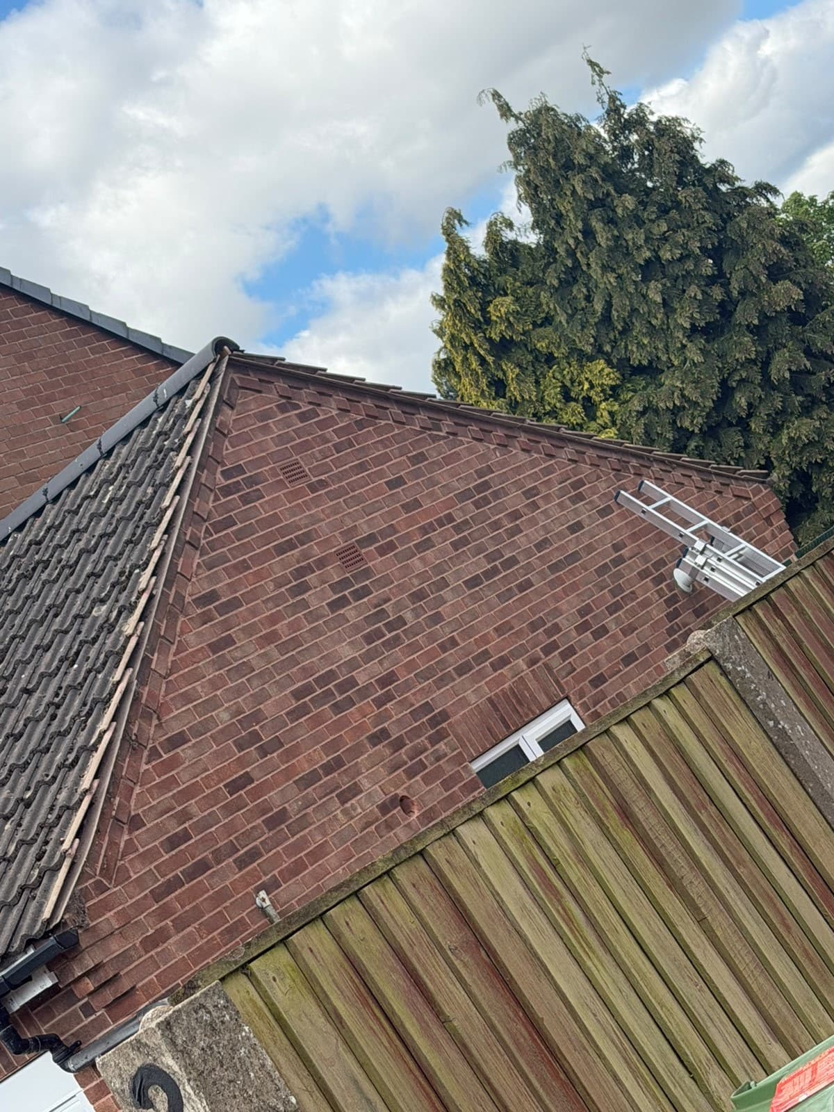 Brick gable end with guttering and bargeboards