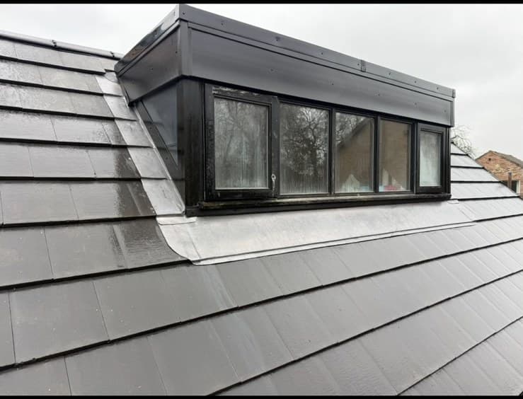 Slate roof with lead flashing around dormer window