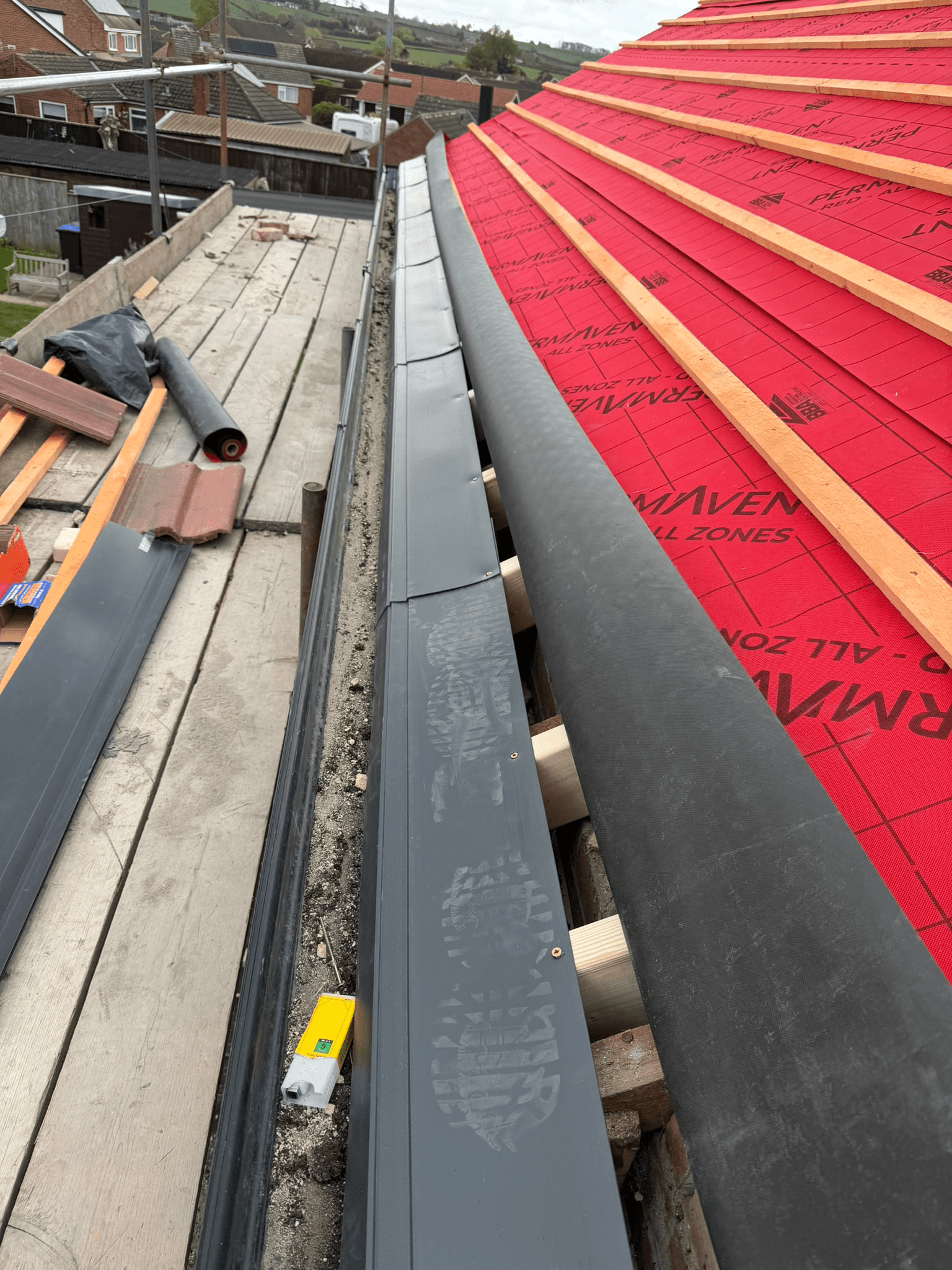 New metal roofline flashing being installed