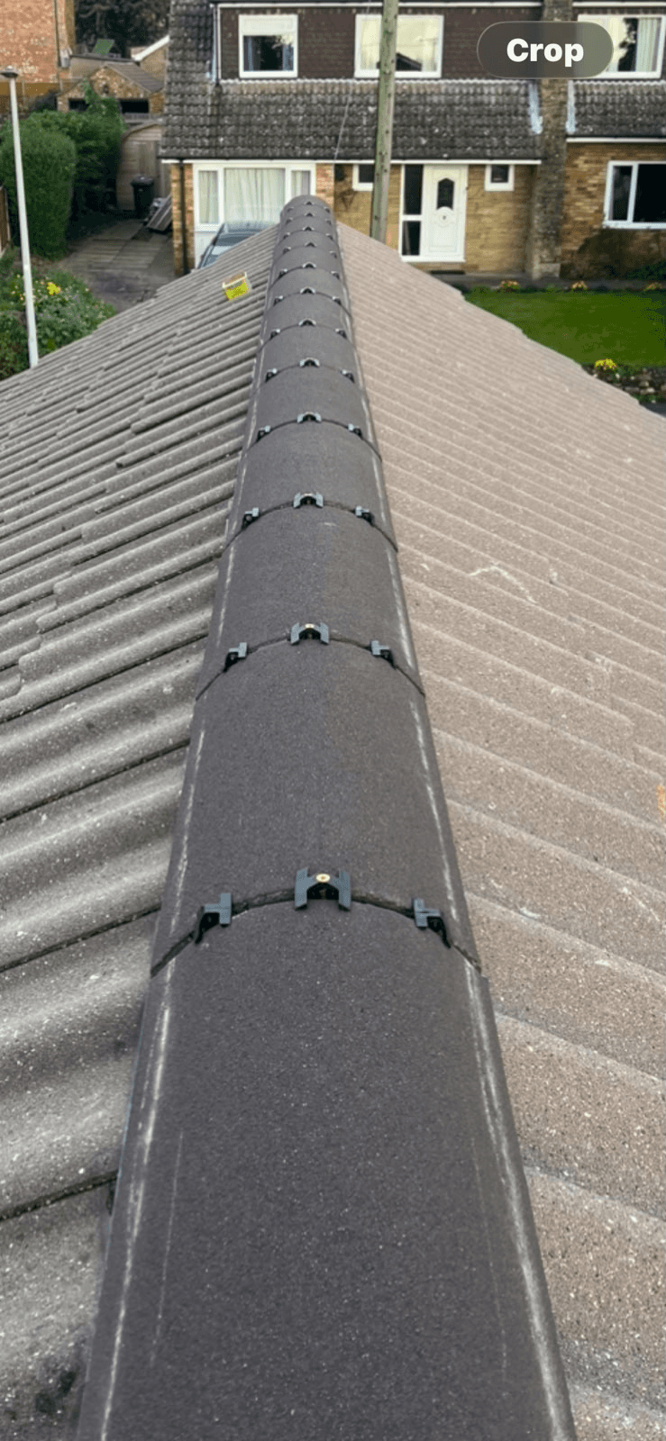 Newly fitted ridge tiles along roofline